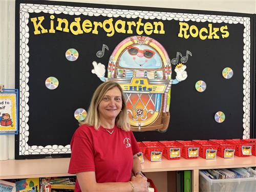Mrs. McNally in Classroom near bulletin board