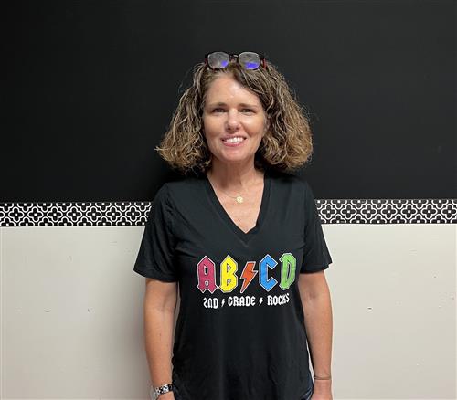 Mrs. Lender in a black T Shirt that Reads ABCD, Second Grade Rocks