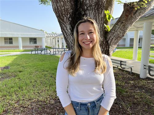 Ms. Dionne standing outside the fourth grade building