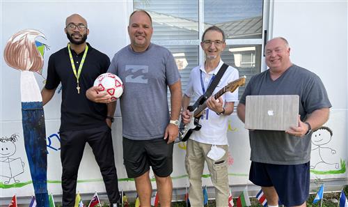 Specials teachers Mr. Vincent, Coach Brouse, Mr. Halil, and Mr. Boehm standing outside.