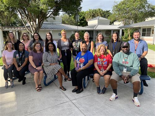 Country Isles Exceptional Student Education Team sitting outside on bench