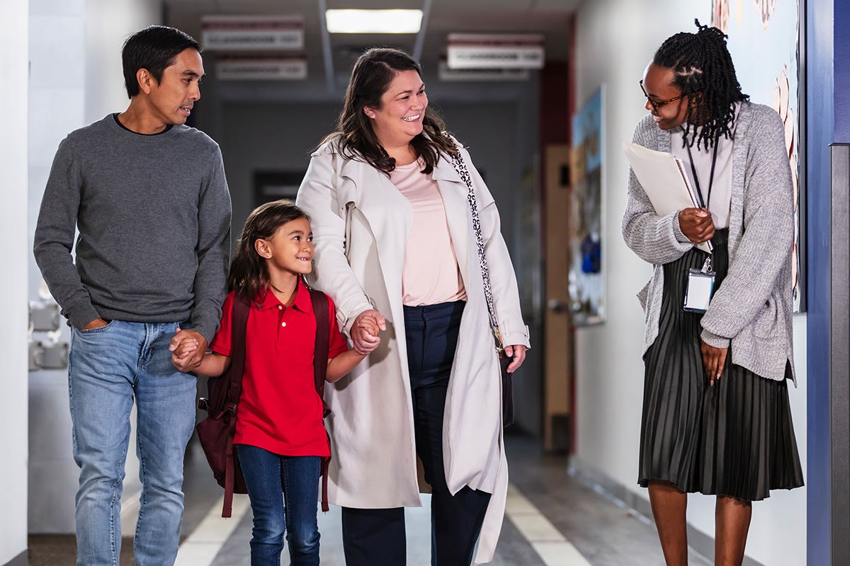 Family with a teacher in a school