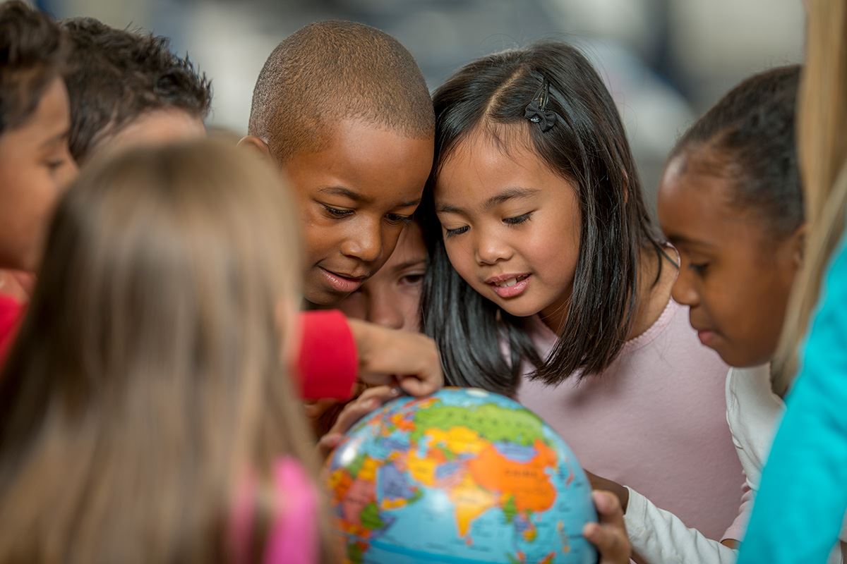 Students looking at a globe