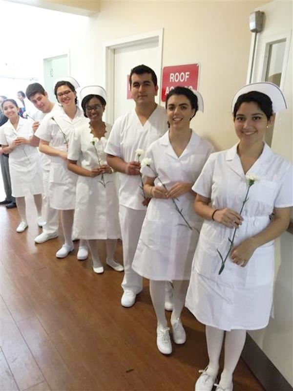 Multiple students dressed in the nurse outfits getting ready for work in the practical nursing class 