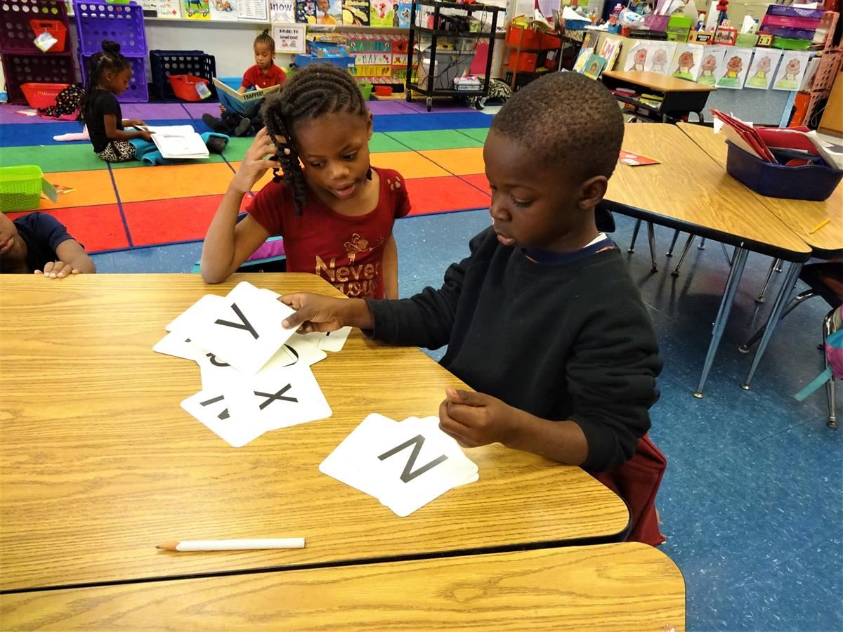 Two students learning the Alphabet.