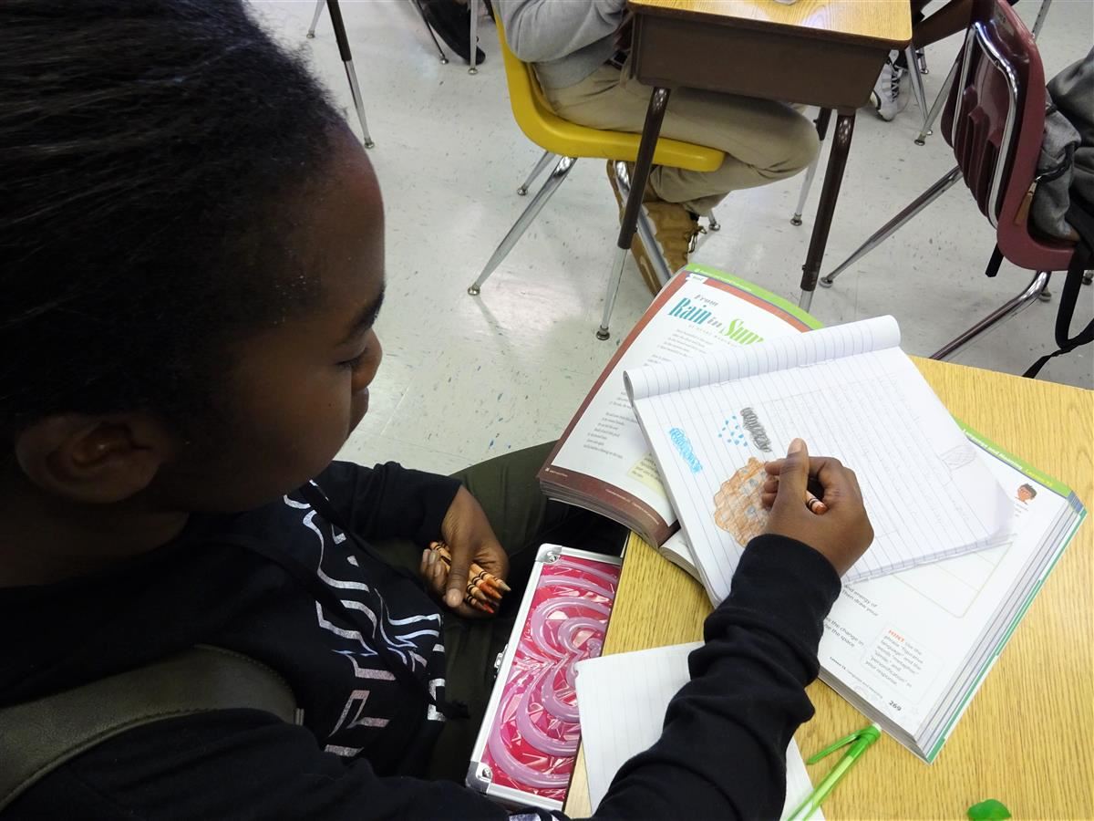 Student drawing an illustration.