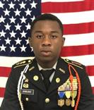 Battalion Executive Officer in uniform with American flag in the background 