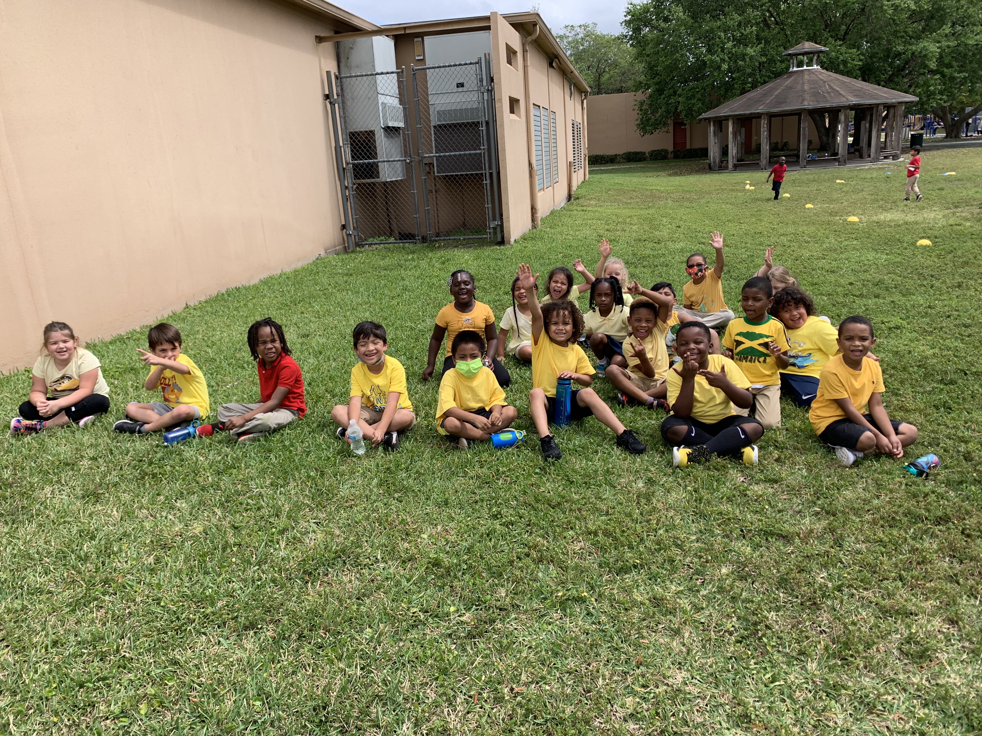 students sitting in grass