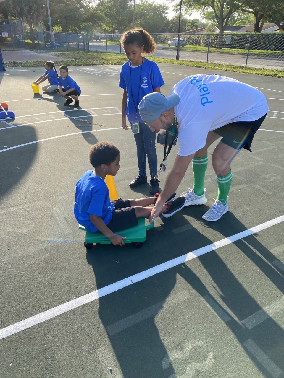 teacher assisting student on push cart