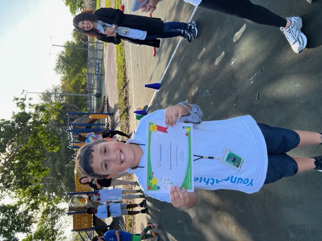 student holding up reward