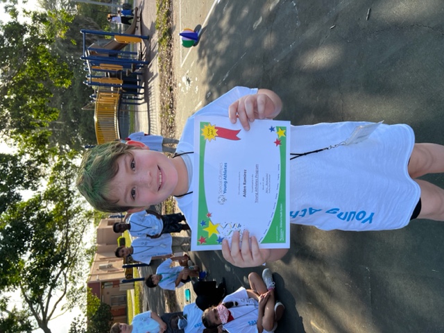 student holding up reward