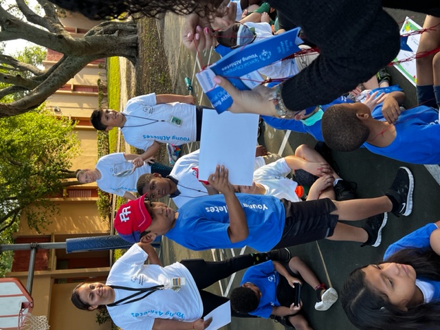 teacher handing out achievement ribbons