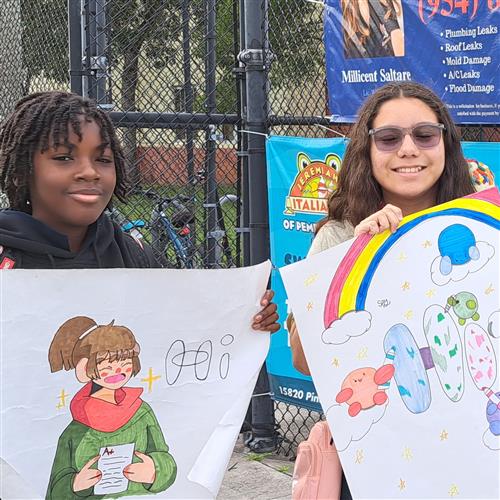 Students holding art