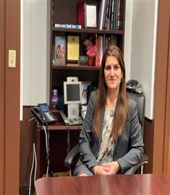 Ms. Loli Formoso Principal sitting at desk