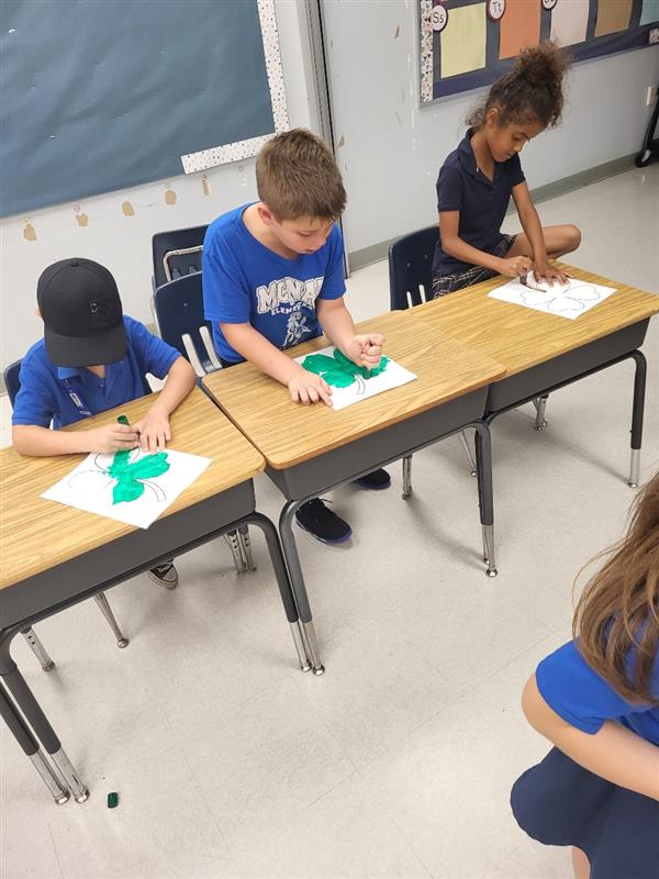 1st Graders making shamrocks