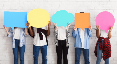 Five middle school students holding colorful speech bubbles