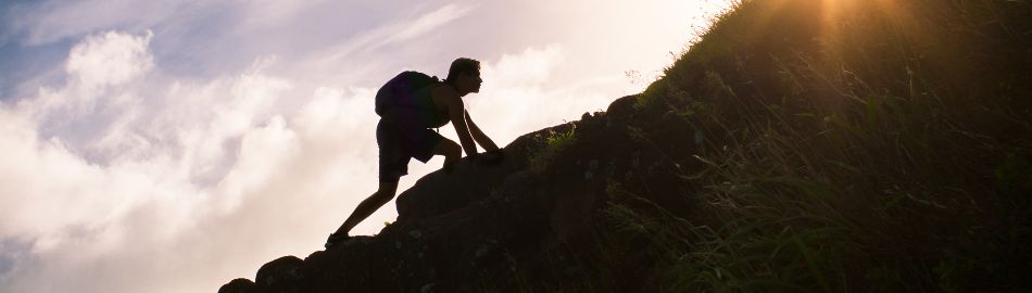 person climbing mountain