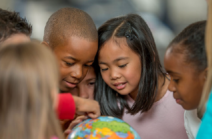 students looking at a globe